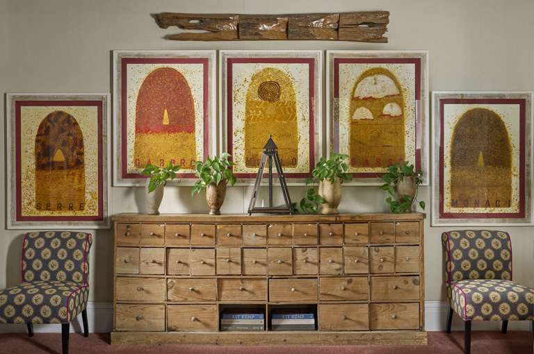 An wide image of the details in the drawing room at Number Sixteen. Focusing on the statement chest of drawers. 