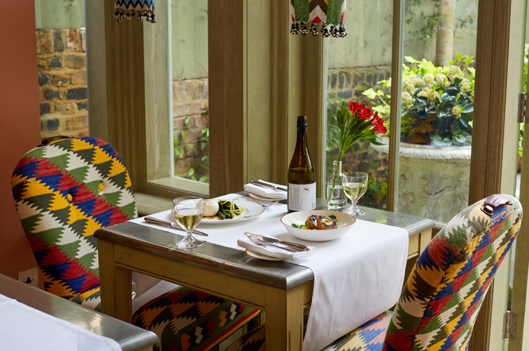 An image of starters on a table The Orangery, Number 16 with, there is a buratta starter and scotch egg starter on mythical creatures crockery.