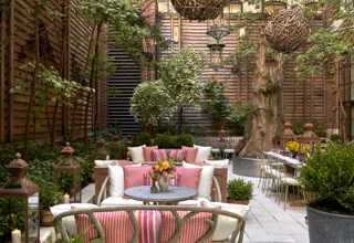 Wide shot of the lounge area of the Sculpture Garden at Crosby Street Hotel