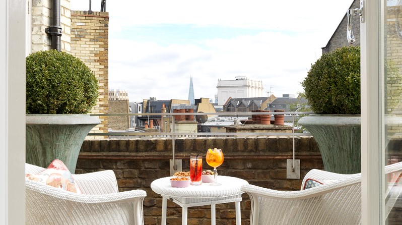 Terrace of the Terrace Suite at Covent Garden Hotel, there is 2 chairs and table over looking the city.