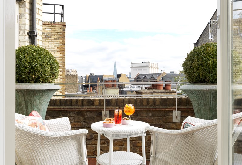 Terrace of the Terrace Suite at Covent Garden Hotel, there is 2 chairs and table over looking the city.