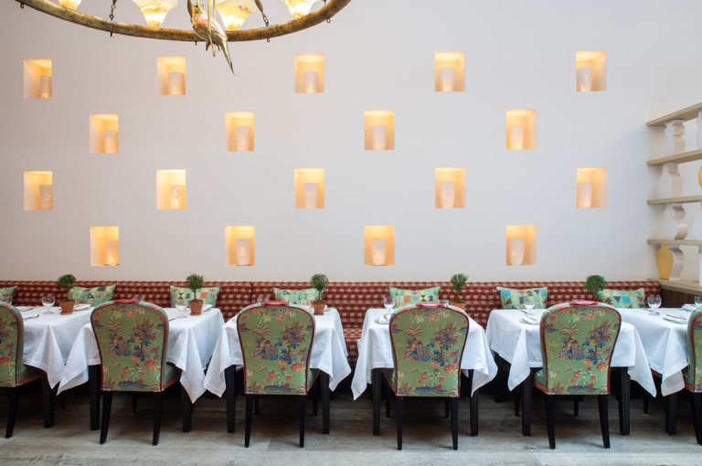 Image of dining tables set-up against the wall with art installation in The Orangery private events room at the Whitby Hotel.