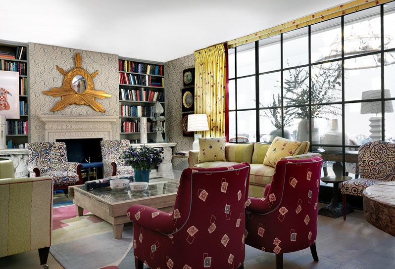 The Drawing Room, with floor to ceiling windows letting in natural light over the lounge styled room with plenty of comfortable seating in bold and colorful arm chairs and sofas.