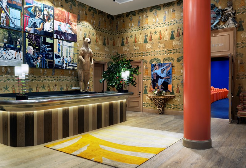 The spacious event lobby featuring original paintings by Peter Rocklin and a large wooden statue of a bear, looking in to the 130 seat state-of-the-art screening room.