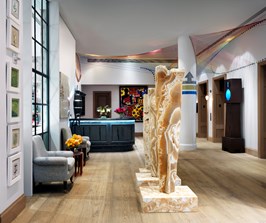 The bright hotel lobby glass windows and striking original artwork, including three stunning marble sculptures by Stephen Cox and the colorful iconic loom by Hermione Skye O'Hea.