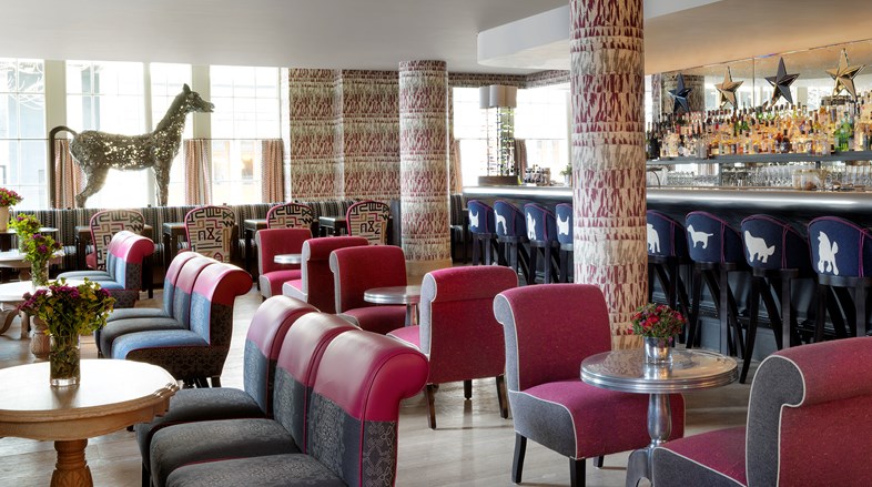 Brumus Bar lounge sitting area featuring fabrics from Kit Kemp's collection for Christopher Farr, with a life size bronze horse standing proudly in the bar.