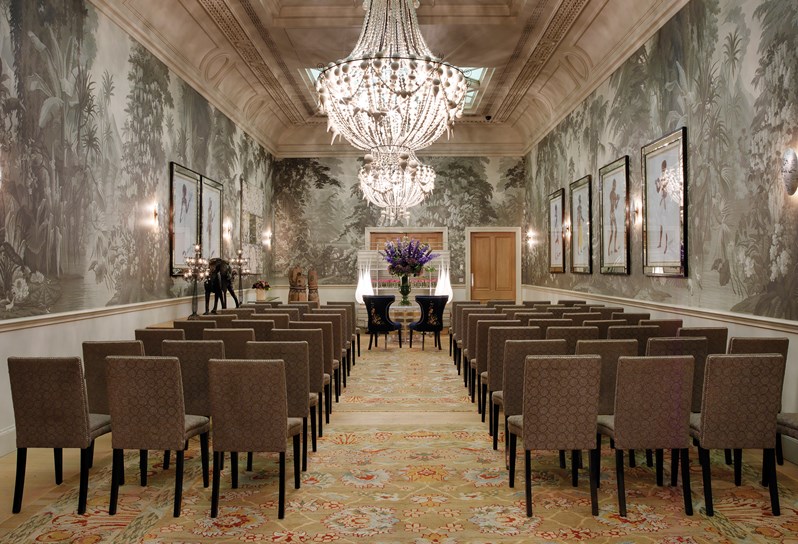 The Shooting Gallery at Haymarket Hotel. Chairs are set up in rows facing forward in preparation for a wedding ceremony.