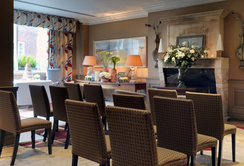 The Drawing Room setup for a wedding ceremony with chairs facing the fireplace.