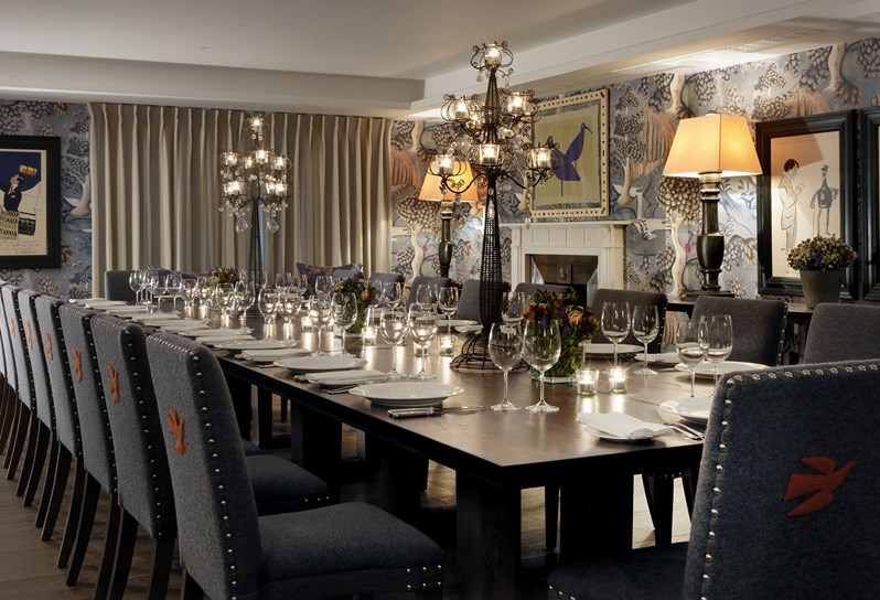 Nash event room with a beautifully set long table and chairs, fresh flowers and ready for an intimate private dinner.