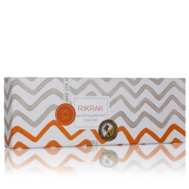 A box of three round soaps scented in gardenia greenleaf. They are presented in an elongated orange box with a lid featuring an orange and grey rick rack design.