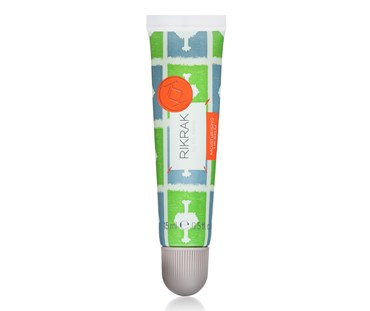 A 15ml tube of RikRak lip balm. Label has a green and blue ozone design applied.