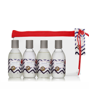 4 100ml plastic bottles of shampoo, conditioner, body wash and body lotion in the scent lavender eucalyptus. The travel kit is presented in a clear plastic pouch with zipper. Label has a blue rick rack design applied.