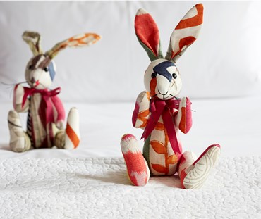 Minnie rabbit patchwork soft toy covered in several of the colourful off cuts of Kit Kemp's fabric designs.