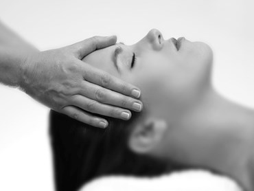 A picture of a female model enjoying a head massage, to illustrate one of the many treatments guests can enjoy at the Soholistic Spa.