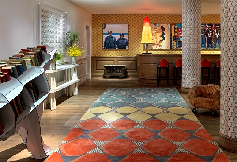 The Events floor lobby with colourful wallpapers and art with a graphic colourful floor rug.