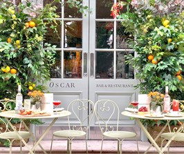 The Aperitivo Terrace at Charlotte Street Hotel, complete with a floral installation, cocktails and food pairings on the table.