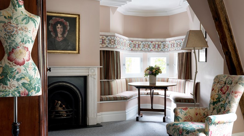 The Junior Loft Suite at Covent Garden Hotel decorated in pale pink tones with a pastel floral fabric