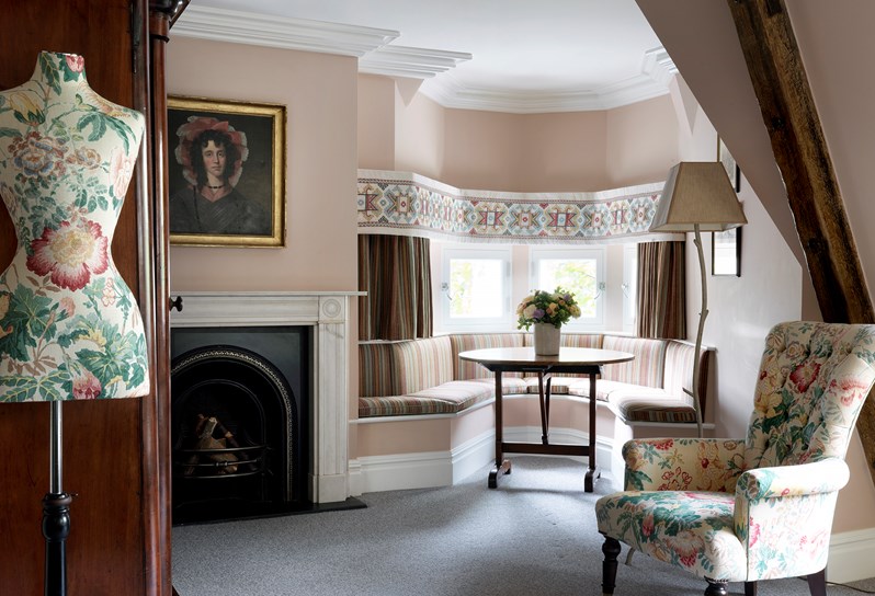 The Junior Loft Suite at Covent Garden Hotel decorated in pale pink tones with a pastel floral fabric