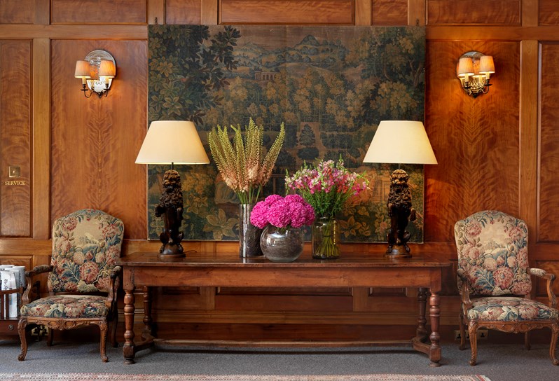 The wood panelled drawing room with tapestry painiting