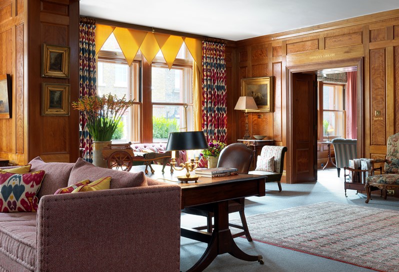 The wood panelled drawing room with open fireplace