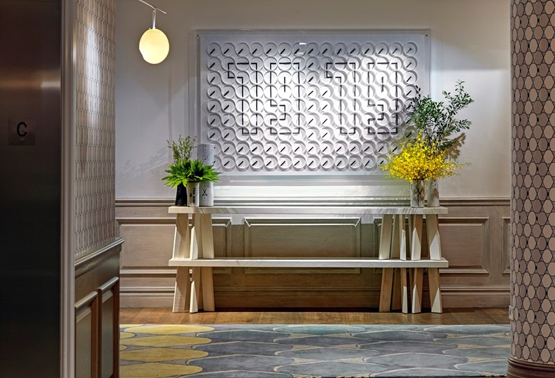 The events lobby at Crosby Street Hotel with a feature clock on the wall