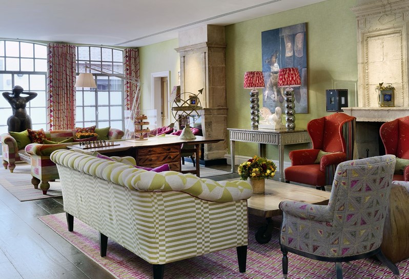 A view looking through the colourful drawing room at The Soho Hotel