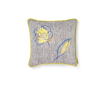 A small square rain shadow green leaf cushion with a combination of chain stitch and stem stitch in shades of sage greens with greys alongside a cobalt blue accent