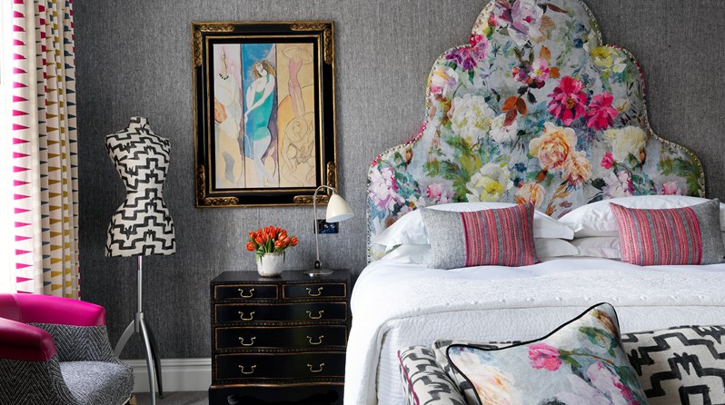 A bedroom with a gorgeous bright coloured floral headboard at Charlotte Street Hotel