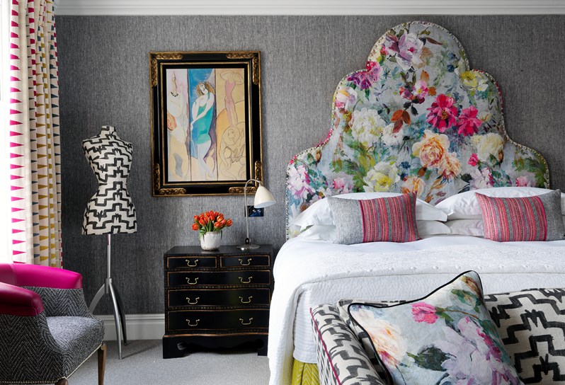 A bedroom with a gorgeous bright coloured floral headboard at Charlotte Street Hotel
