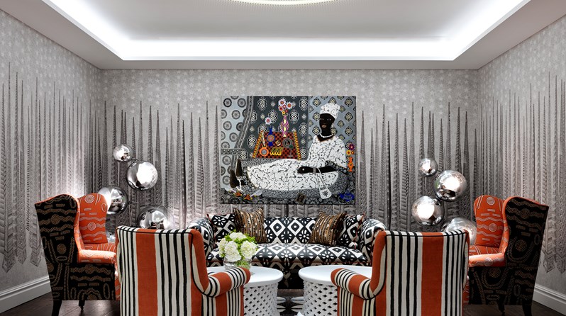 A meeting room with a graphic striped wallpaper and a colourful painting of lady. There are two orange striped armchairs in the foreground