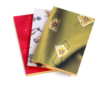 3 notebooks in three different Kit Kemp's designs for Chelsea Textiles: Friendly Flowers, Mythical Creatures and pink Moondog.