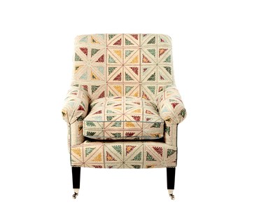 An armchair upholstered in a geometrical pattern.