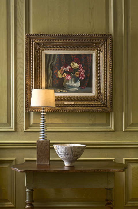 Close shot of artwork in the Library at Charlotte Street Hotel, with two chairs.