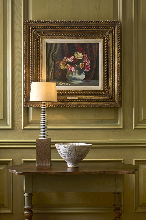 Close shot of artwork in the Library at Charlotte Street Hotel, with two chairs.