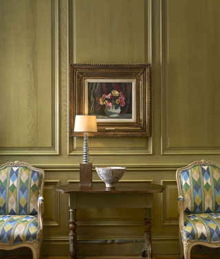 Close shot of artwork in the Library at Charlotte Street Hotel, with two chairs.