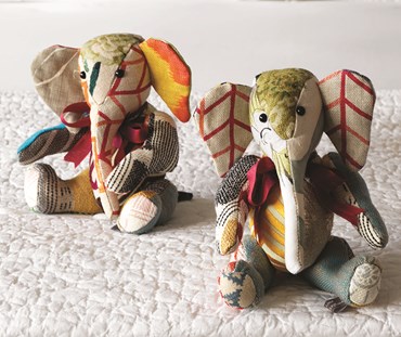 Two Jambo Elephant patchwork soft toys covered in several of the colourful off cuts of Kit Kemp's fabric designs.