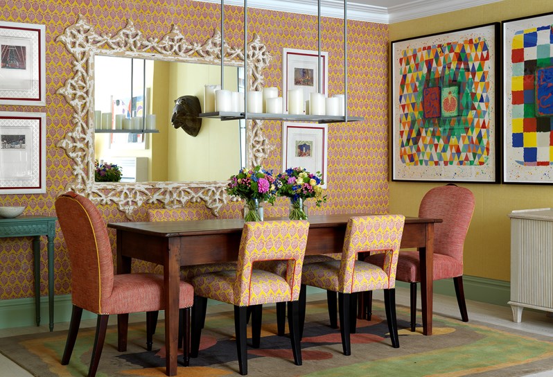 The dining area lined with bright and colourful wallpaper in the Oak Leaf Suite at Ham Yard Hotel