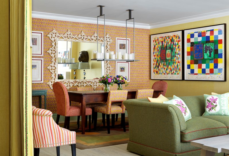 The dining area lined with bright and colourful wallpaper in the Oak Leaf Suite at Ham Yard Hotel
