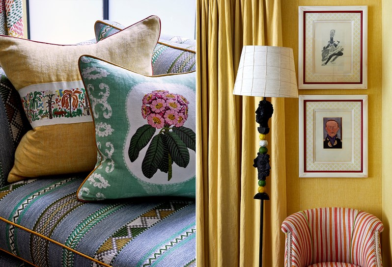 A detail of two floral cushions on a sofa with a pale yellow wall in the background