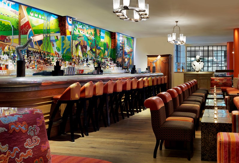 Refuel Bar with lounge style seating and bar with colourful mural adorning the wall