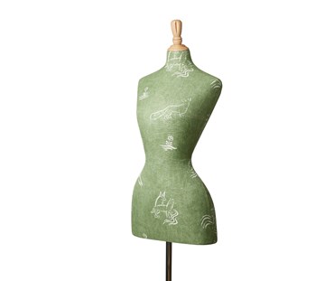 Side view of Mannequin with Kit Kemp's Friendly Folk basil green fabric for Andrew Martin