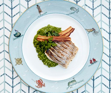 Sea bass with a vibrant parsley risotto on Kit Kemp's Sailor's Farewell china plate