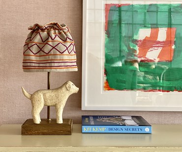 Dog lamp at Soho Hotel on a table with the Design Secrets book.