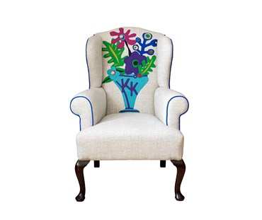 The completely bespoke Couture Wing chair with personalized initials woven into a Matisse inspired applique design. The chair features one of Kit's favorite fabrics, Pierre Frey’s plain linen ‘Arsene’, as a fresh background against a selection of moon wools for the cut outs and piping.
Front View