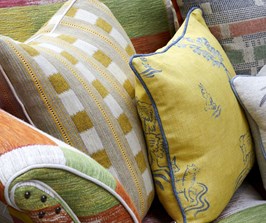 A collection of colourful cushions resting on a sofa.