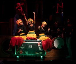 Sophia Mackay as Judy Mowatt, Gabrielle Brooks as Rita Marley, Melissa Brown Taylor as Marcia Griffiths on stage in Get Up Stand Up! The Bob Marley Musical