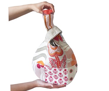 Hands holding knot bag