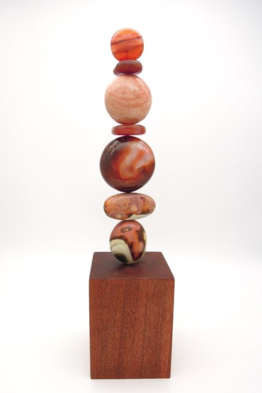TOTEM 40 is entirely unique made from 2 x Carnelian, Peach Moonstone, Carnelian, Carnelian, 2 x Polychrome Jasper. The stones are supported on a central support sitting on a sapele wood base.