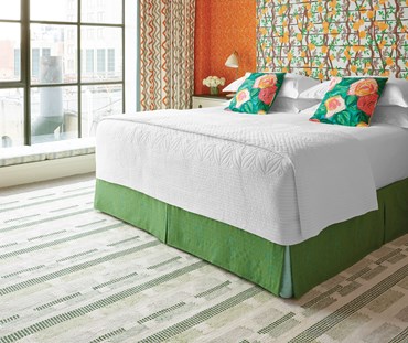 Tonal dotted strips of color on a white ground randomly break at intervals in this witty cotton flatweave rug design