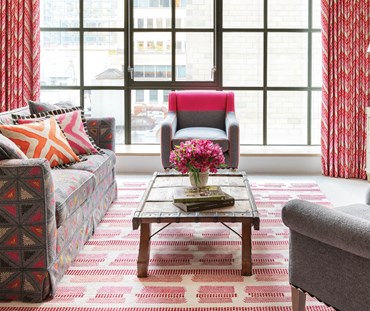 Tonal dotted strips of color on a white ground randomly break at intervals in this witty cotton flatweave rug design
